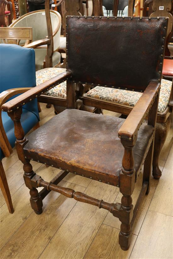 An oak and leather elbow chair
